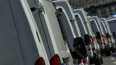 Convoy of police cars arriving at destination, public order guard in city