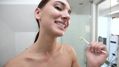 Teeth Hygiene. Woman Brushing Teeth And Looking At Camera