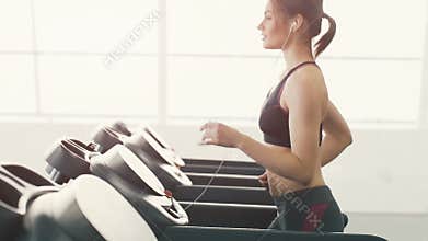 Pretty girl jogging in gym