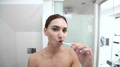 Teeth Hygiene. Woman Brushing Teeth And Looking At Camera