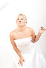 Portrait of pretty bride in white wedding gown