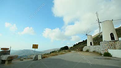 Panning shot of the historic windmills on mykonos,