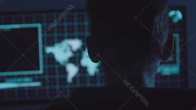 Young Hacker doing Attack on Data Servers and bank`s account to still the secret credit card numbers. Working in sci-fi