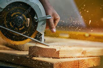 Circular Saw. Carpenter Using Circular Saw for wood beam