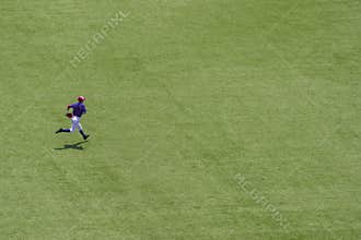 American youth baseball player running on field