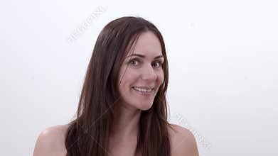 Portrait of smiling brunette woman, turning her head to the left and to the right. Looking in to teh camera. Isolated