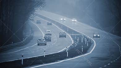 Bad weather driving - foggy hazy country road. Motorway - road traffic. Winter time