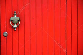 Vintage red door and brass knob in Italy