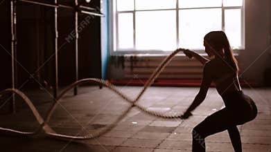 Beautiful athletic woman working out with ropes box gym copyspace confidence motivation sports lifestyle activity hobby