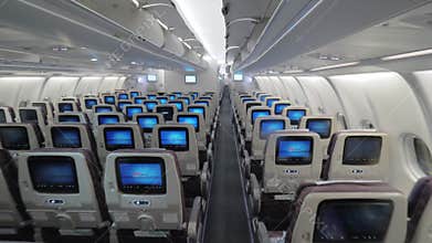 Jet airplane interior view economy class monitors on seats