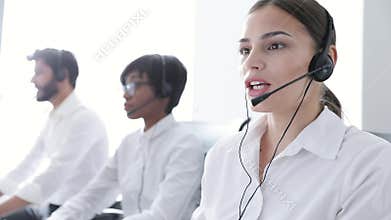 Call Center Agents Consulting Clients On Hotline At Office