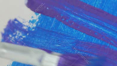 Close Up Image with a Paint Brush Coloring a Painting with Blue Color
