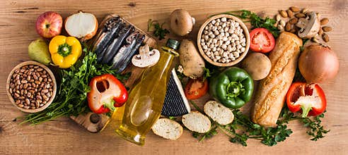 Healthy eating. Mediterranean diet. Fruit,vegetables, grain, nuts olive oil and fish on wood