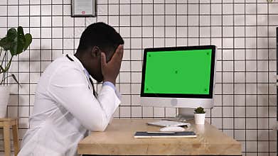 Shocked medical doctor looking on the screen of computer. White Display.