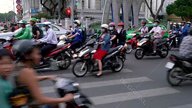 Scooters, motorcycles, cars, traffic and people pedestrian crossing, Saigon or Ho Chi Minh City, Vietnam