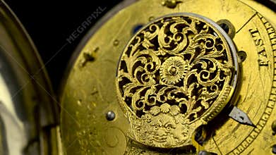 Mechanism vintage pocket watch against rotate the black background. Close up . Sound