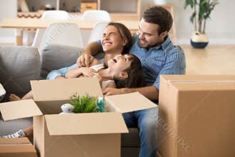 Laughing family spend time having fun at new home