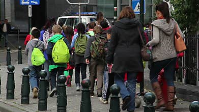 Group of children organized walk accompanied adults museum visit