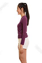 Profile view of young happy Asian teenage girl smiling