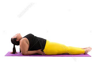 Studio shot of young fat Asian woman lying down and doing yoga p