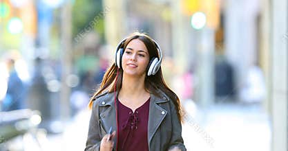 Teen listening to music dancing in the street