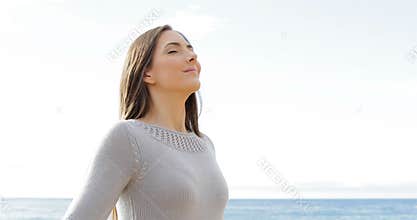 Happy lady breathing fresh air on the beach