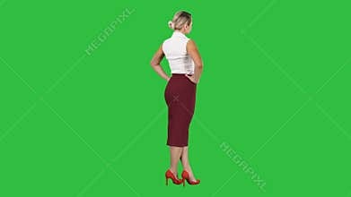 Woman putting her hands on her hips on a Green Screen, Chroma Key.