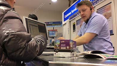 Motion of people buying grocery at check out counter