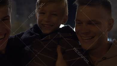 Happy same sex family with firework sparkles celebrating Christmas, adoption