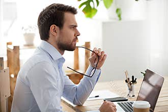 Pensive male employee think of problem solution