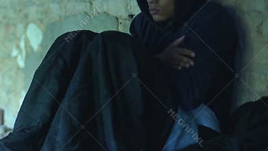 African-american teenager spending nights in cold underground passage, poverty