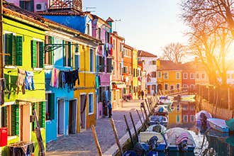 Lovely house facade and colorful walls in Burano, Venice. Burano island canal, colorful houses and boats, Venice landmark, Italy.