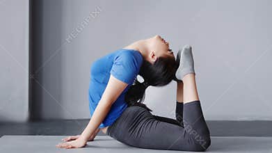 Asian flexible women practicing yoga in studio indoor fitness female with perfect stretching
