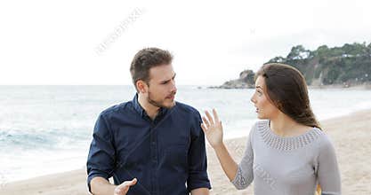 Couple or friends arguing on the beach