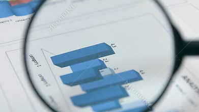 Rotation. Studying diagrams with a magnifying glass. Financial analysis.
