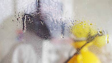 Close up exterminator in overalls and in a protective mask carries out surface treatment with pesticides slow mo