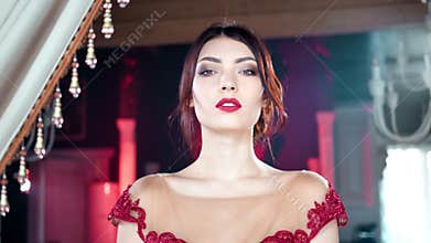 Panning shot medium closeup playful adorable seductive young woman posing at vintage luxury interior