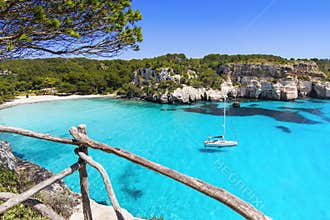 Beautiful Cala Macarella beach, Menorca island, Spain. Sailing boat in a bay. Summer fun, enjoying life, yachting, travel and acti