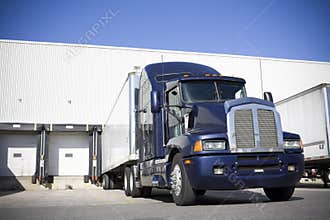 Blue Transport Truck Docking in yard