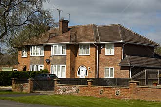 Traditional, tipycal english house. Brick stone house. street view. Spring time