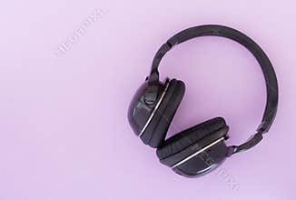 Wireless headphones are isolated on a pink background, the top view. Musical concept