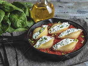 Pasta conchiglioni stuffed spinach and cheese, tomato sauce cooked