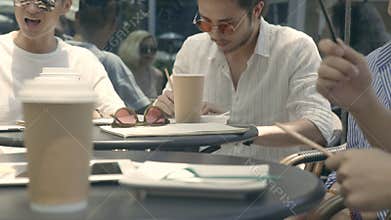 Members of a rock band discussing music outdoors