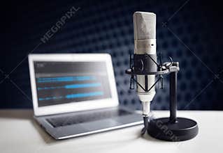 Podcast microphone and laptop computer in recording studio