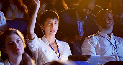 Young Asian businesswoman raising hand in business seminar at auditorium 4k