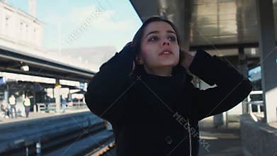 Desperate woman standing on platform, late for train, lost her last chance