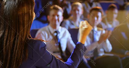 Young businesswoman speaking on stage in auditorium 4k