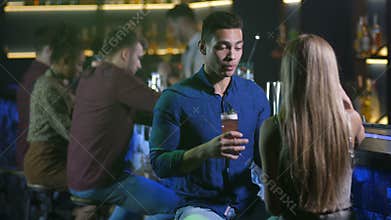 Handsome arab man conversating with woman at bar