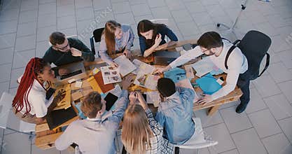 Top view group of multiethnic professional business people work together, male boss leading the meeting at modern office