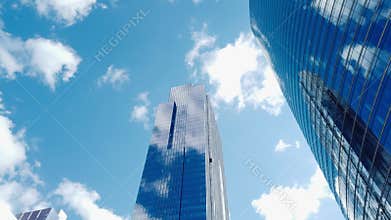4K UHD Motion time-lapse of buildings in business district, sunny day fast moving cloud. Financial economy, construction industry